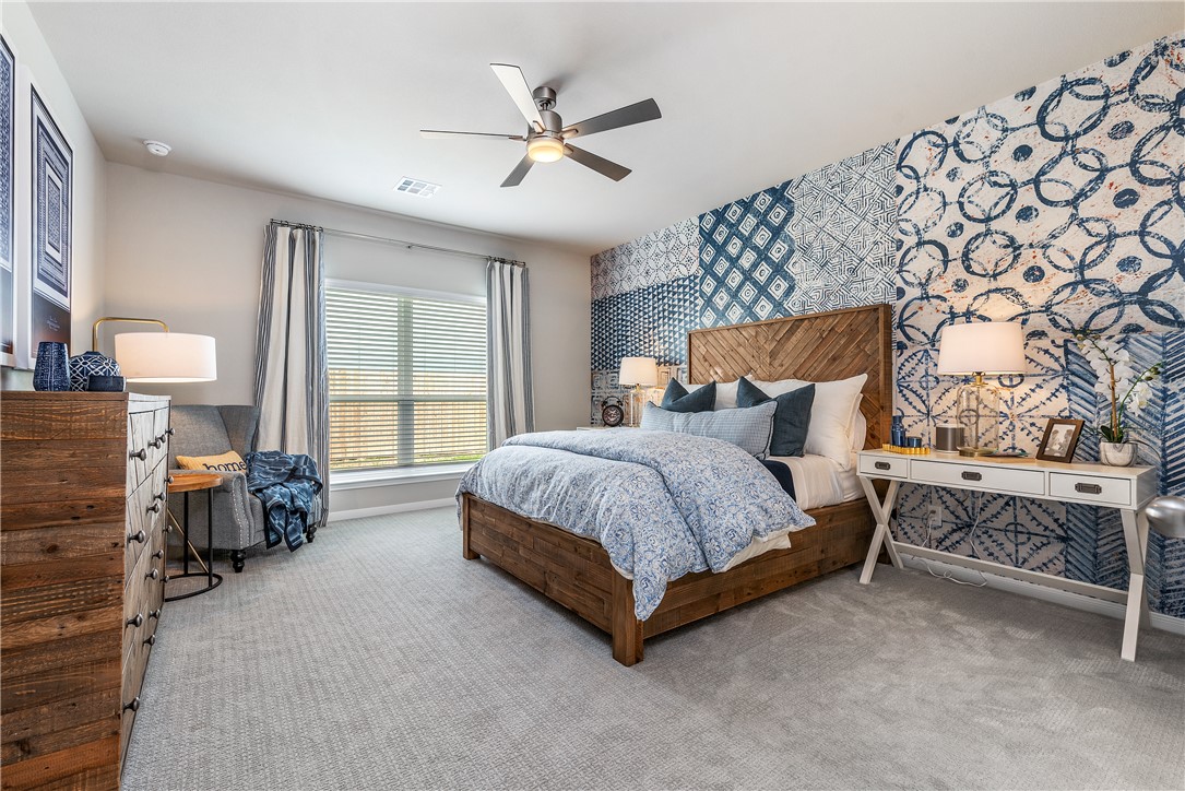 6309 Raleigh Drive College Station, TX 77845 - Photo 5 of 18 a spacious bedroom with a bed and a chandelier