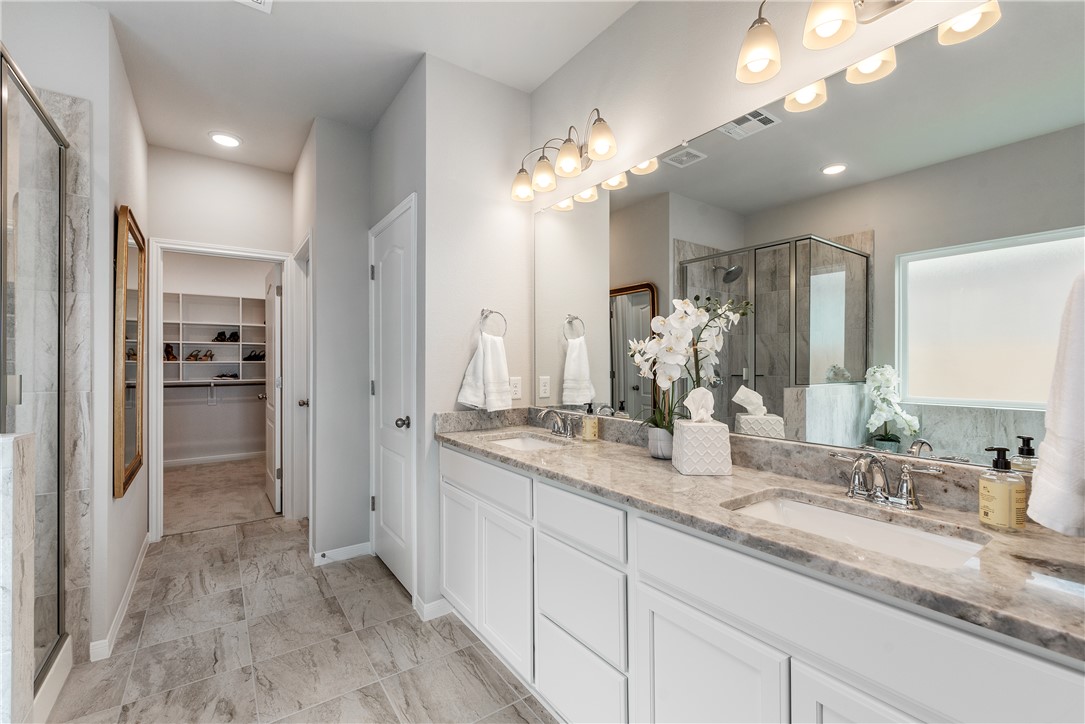 6309 Raleigh Drive College Station, TX 77845 - Photo 6 of 18 a bathroom with a double vanity sink and a mirror