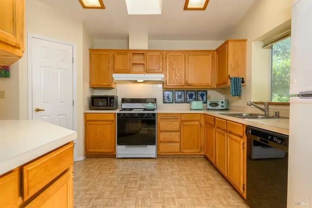 a kitchen with a sink stove and cabinets