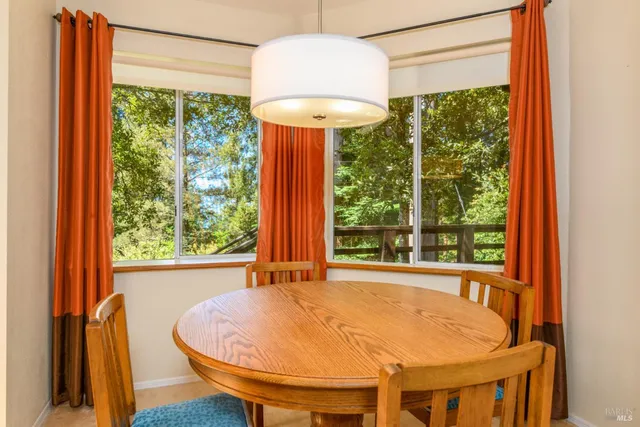 a dining room with a window and a table