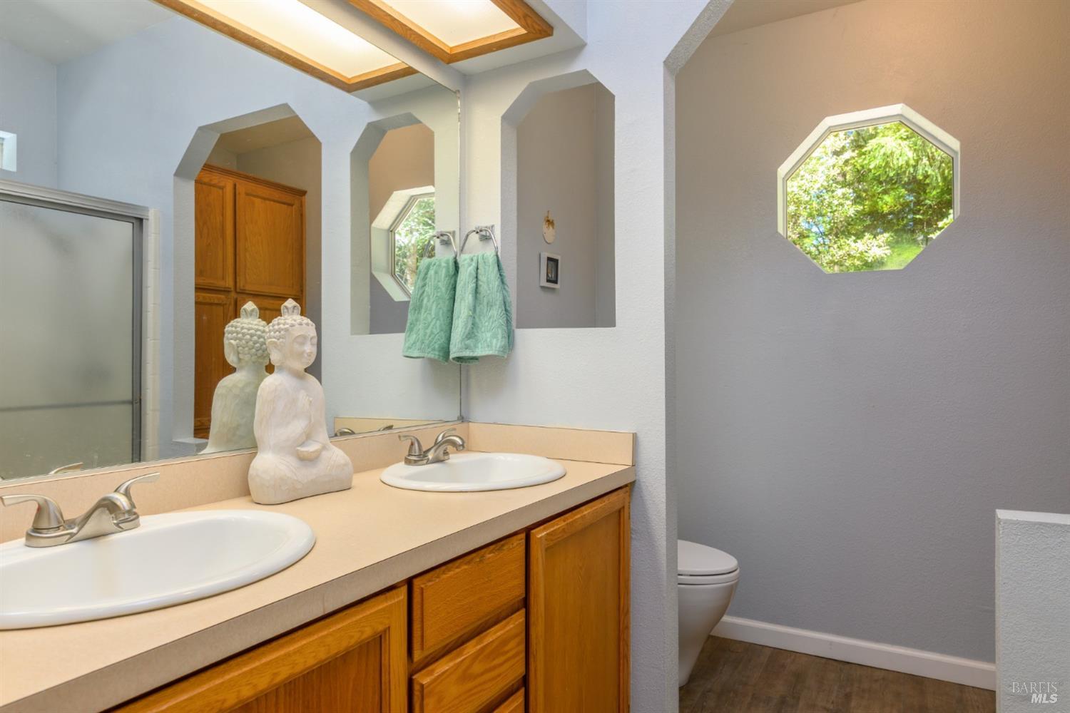 35551 Ocean View Street Gualala, CA 95445 - Photo 19 of 26 a bathroom with a toilet sink and mirror