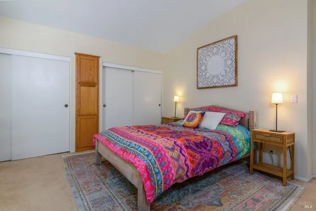 a bedroom with a bed and a lamp