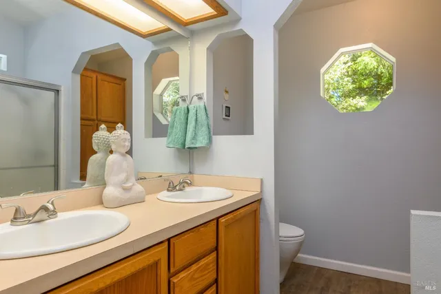 a bathroom with a toilet sink and mirror