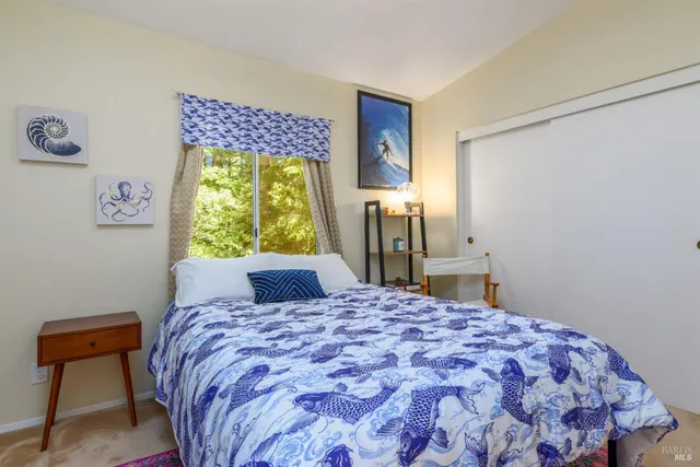 a bedroom with a bed and a window