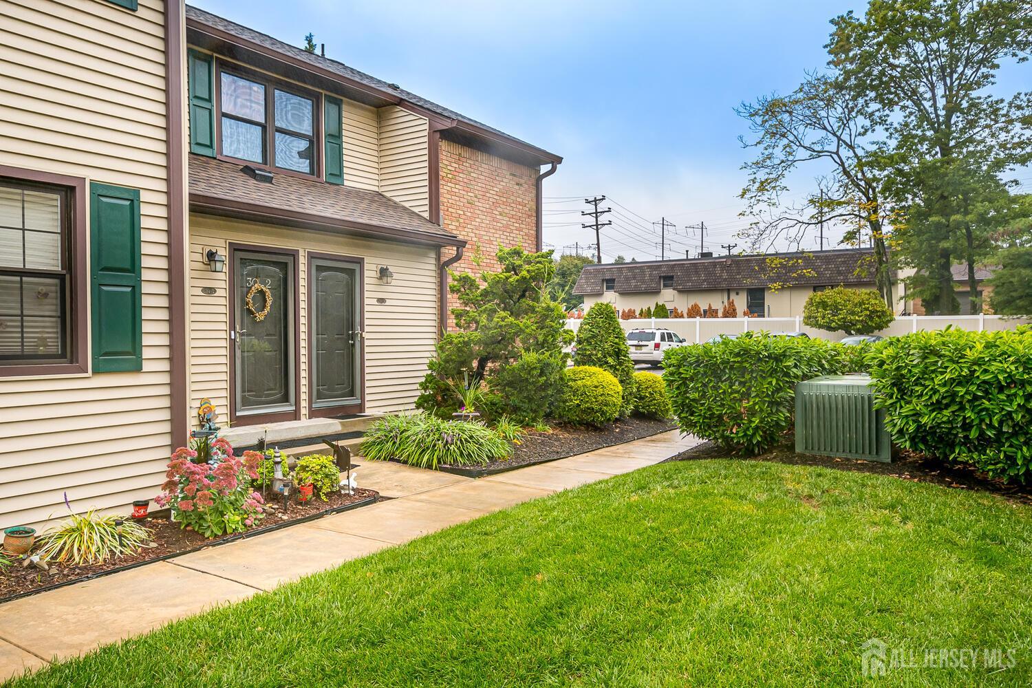 30-5 Prospect Street, Unit 2 Metuchen, NJ 08840 - Photo 2 of 23 a front view of a house with a garden and plants