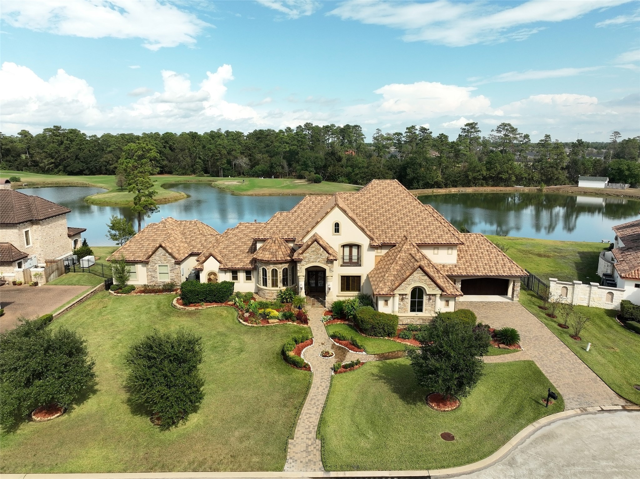 a aerial view of a house with a yard and lake view