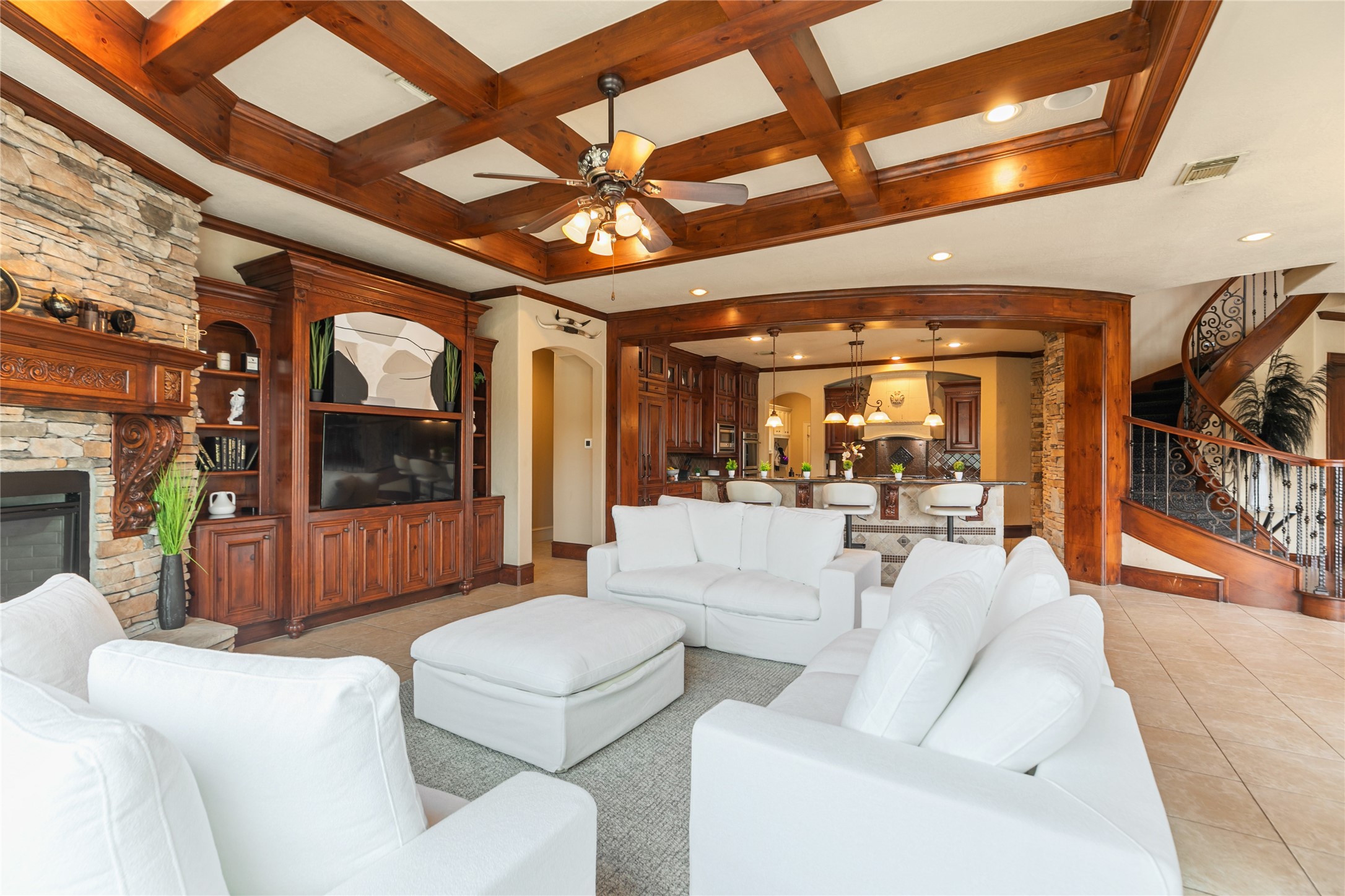 22 Post Shadow Estate Drive Spring, TX 77389 - Photo 27 of 50 Inviting den highlighted by gorgeous accent beams and a stone fireplace with view of the kitchen.