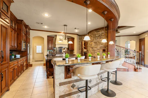 a large kitchen with a table chairs stove and wooden floor