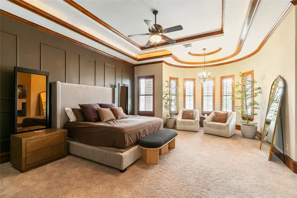 a living room with furniture a flat screen tv and floor to ceiling window