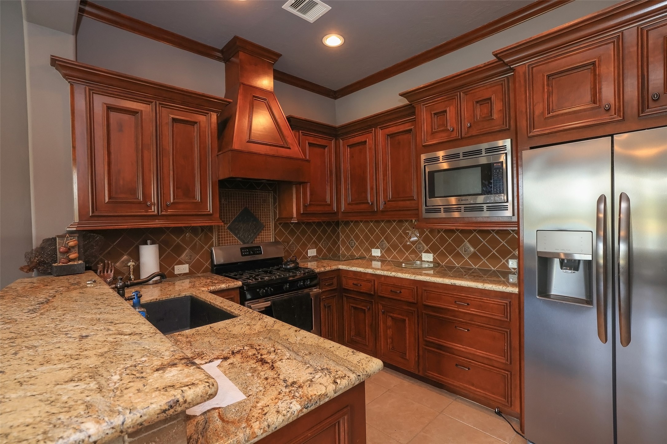 22 Post Shadow Estate Drive Spring, TX 77389 - Photo 47 of 50 a kitchen with stainless steel appliances granite countertop a sink stove and refrigerator