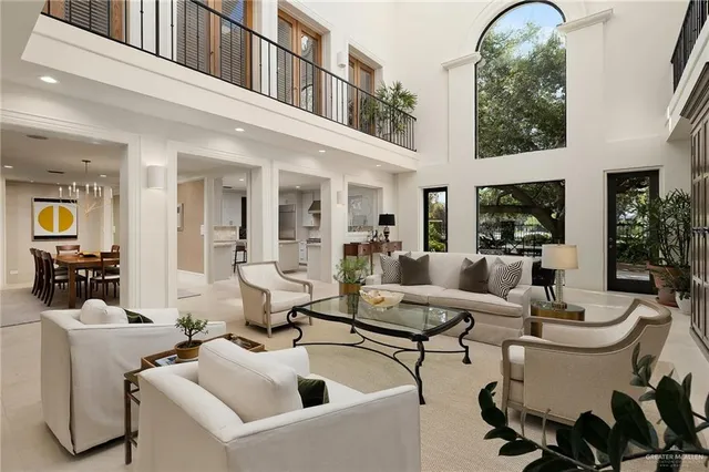 a living room with furniture a fireplace and potted plants