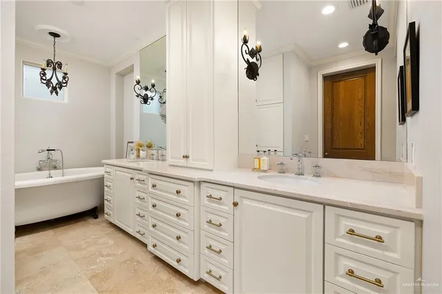 a bathroom with a double vanity sink a large mirror and a bathtub
