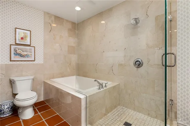 a bathroom with a toilet a sink and shower