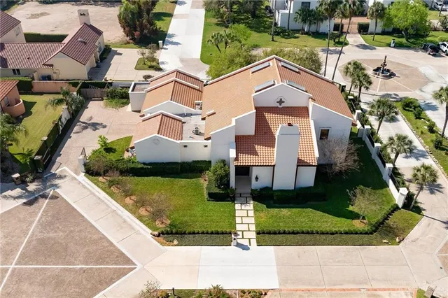 an aerial view of residential houses with outdoor space and parking