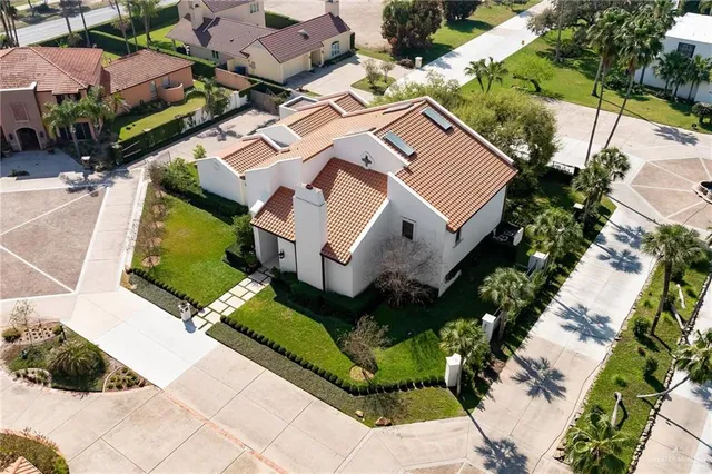 an aerial view of a house with a yard