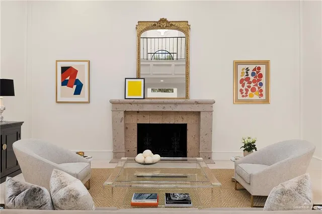 a living room with furniture and a fireplace