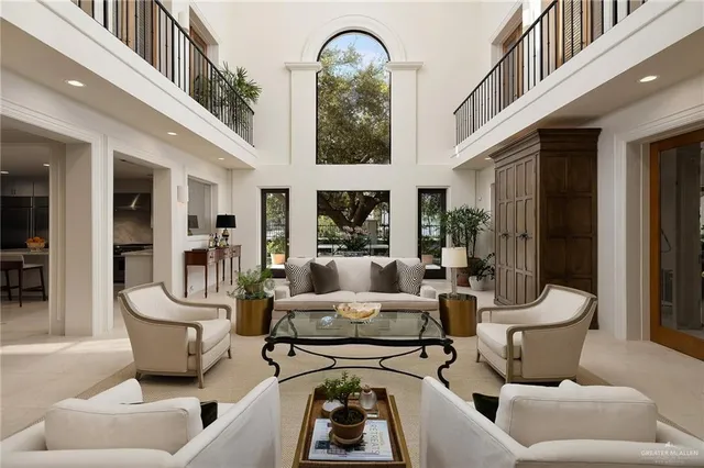 a living room with furniture fireplace and a large window