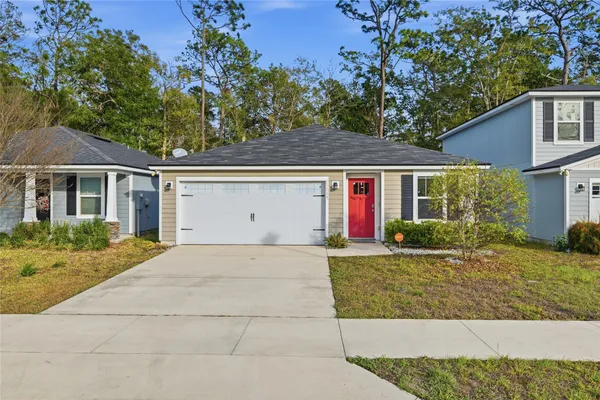 a front view of a house with a yard and garage