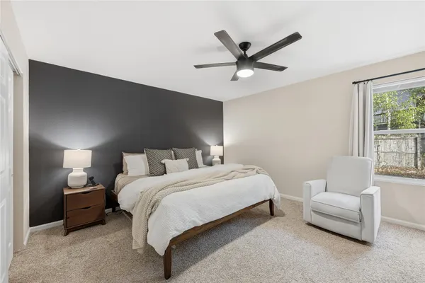 a bedroom with a bed and a couch