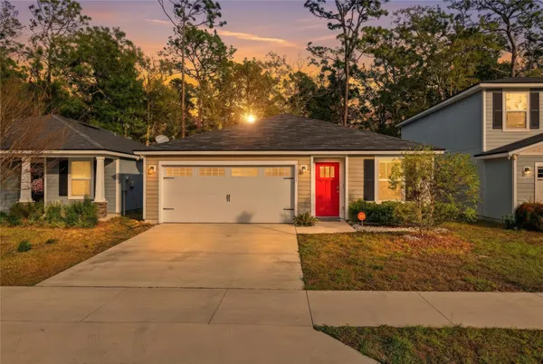 a front view of house with yard and trees around