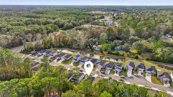 an aerial view of a house with a yard