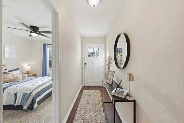 a bedroom with bed and a mirror