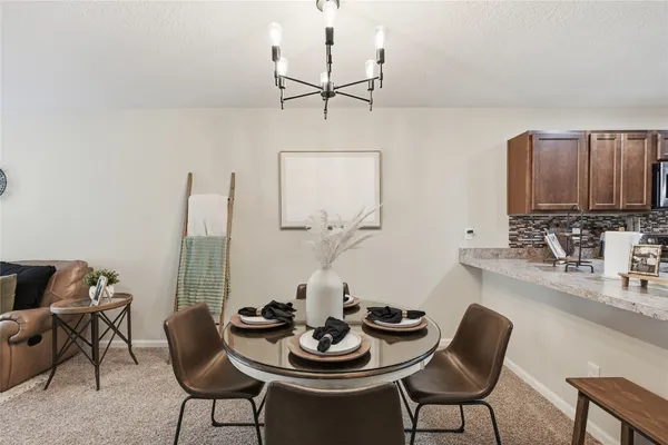 a dining room with furniture and window
