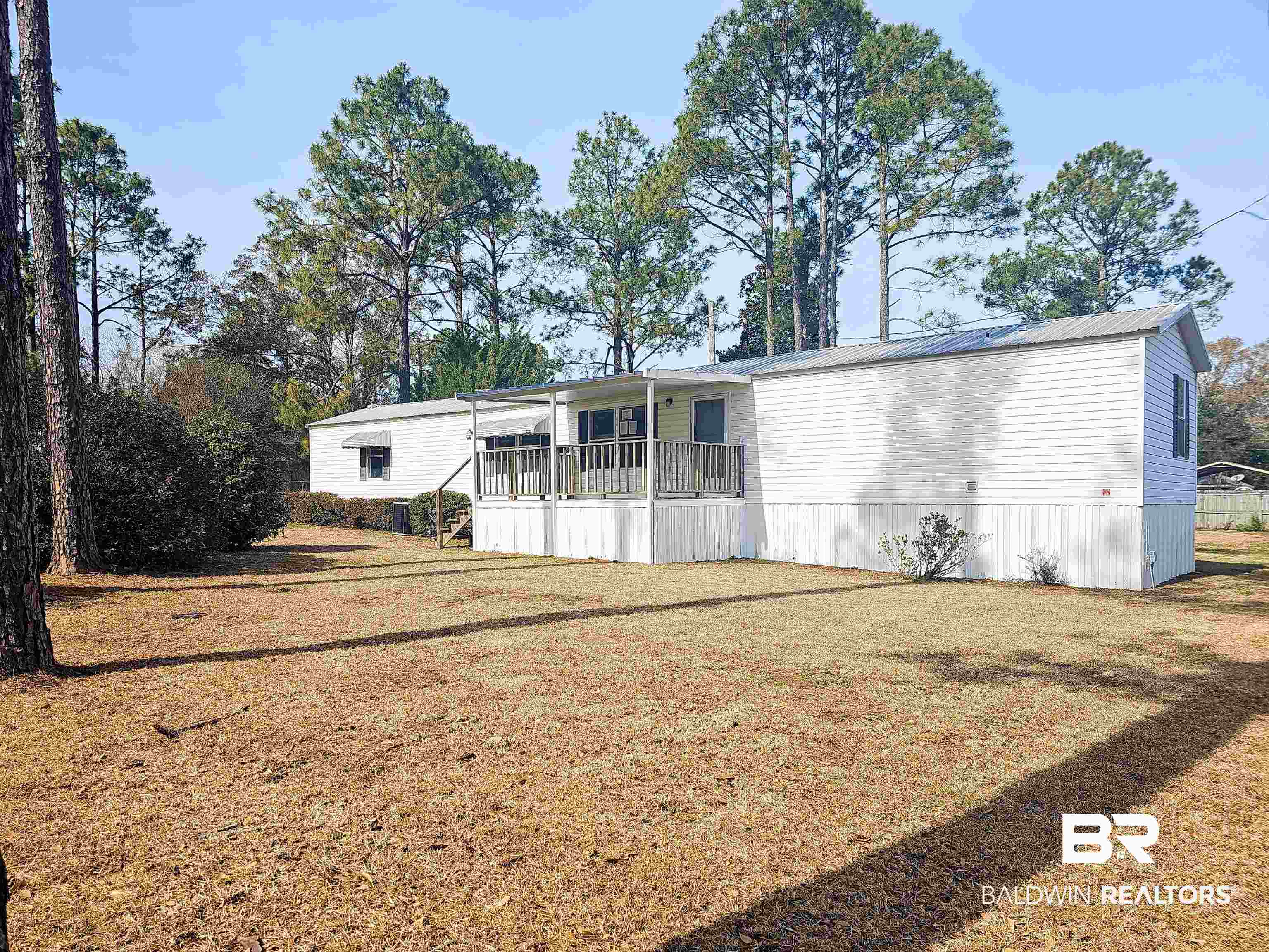 18659 Bull Springs Road Robertsdale, AL 36567 - Photo 1 of 25 Rear view of house featuring a porch and a lawn