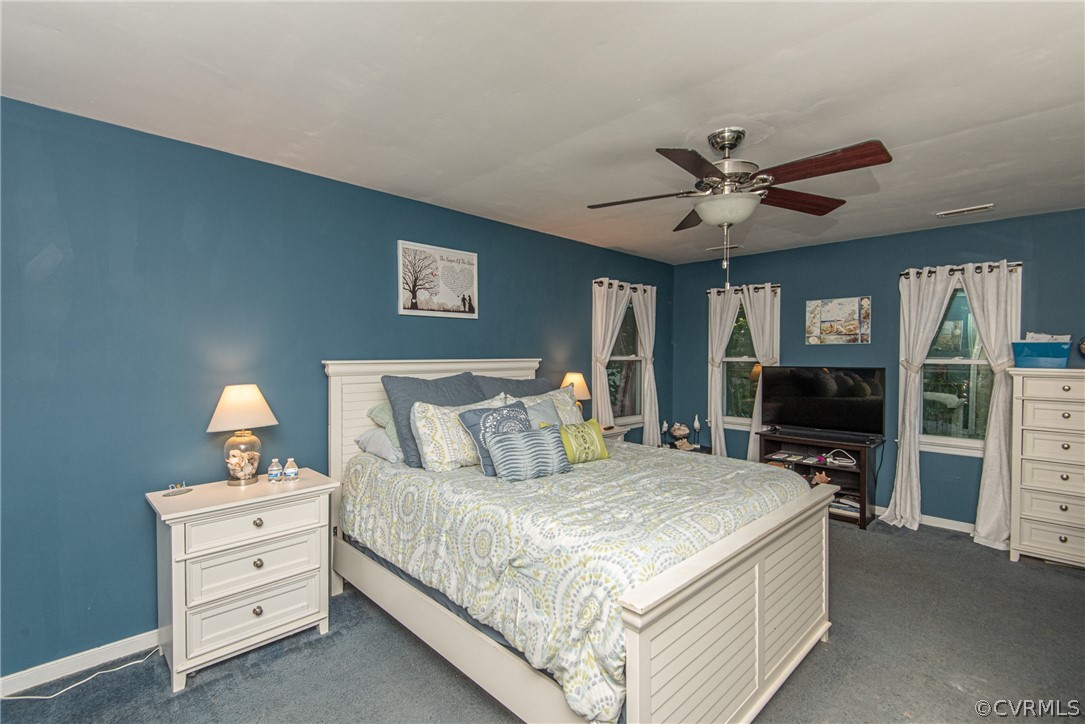 10719 Ridgerun Road Chesterfield, VA 23832 - Photo 17 of 26 a bedroom with a large bed and a flat tv screen on dresser
