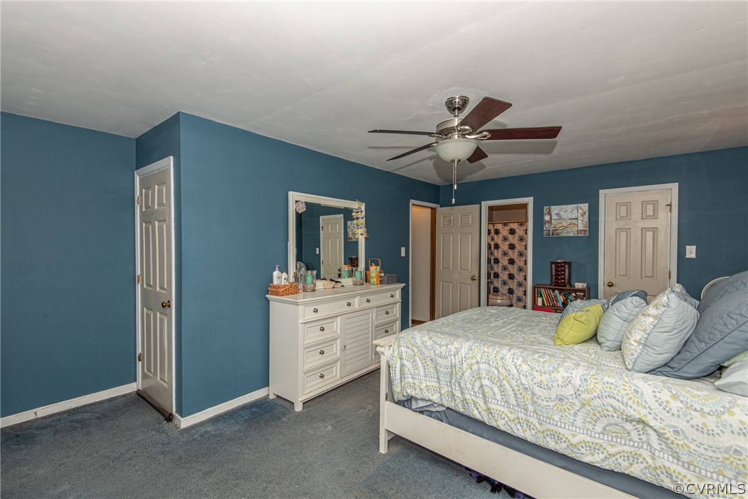 10719 Ridgerun Road Chesterfield, VA 23832 - Photo 18 of 26 a bedroom with a bed and a chandelier