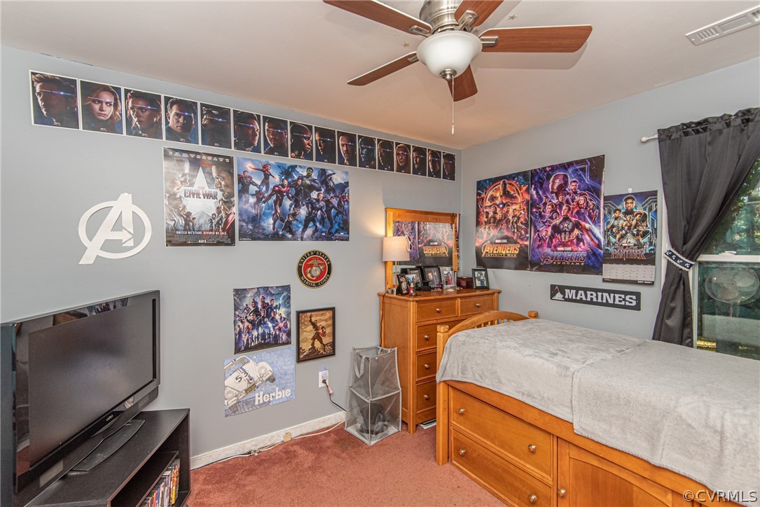 10719 Ridgerun Road Chesterfield, VA 23832 - Photo 22 of 26 a bedroom with a bed and a flat screen tv