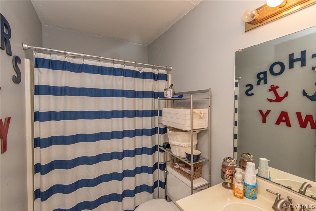 10719 Ridgerun Road Chesterfield, VA 23832 - Photo 24 of 26 a bathroom with a sink toilet and shower