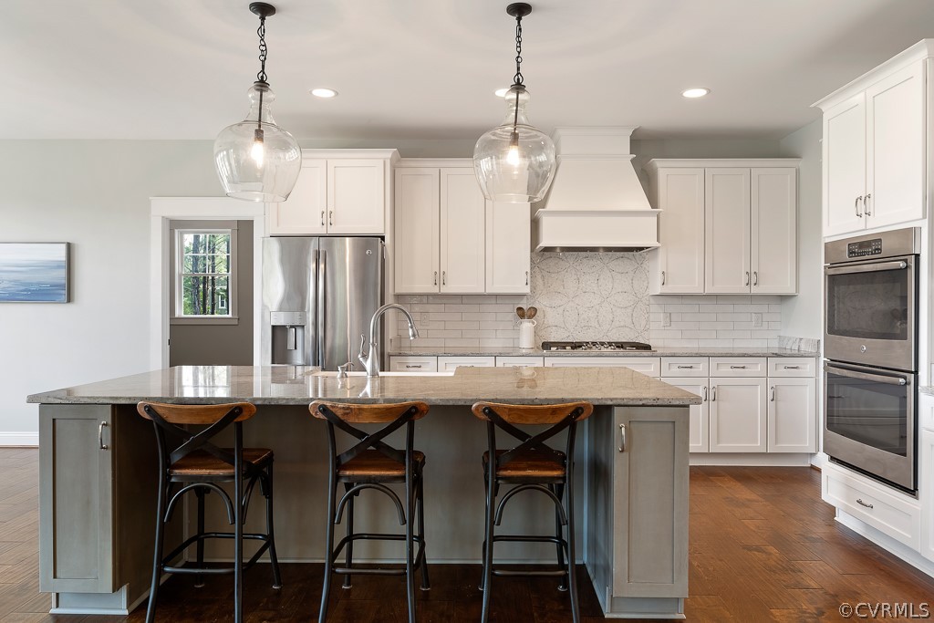 3812 Millmount Drive Powhatan, VA 23139 - Photo 14 of 48 a kitchen with stainless steel appliances kitchen island granite countertop a table chairs sink and cabinets
