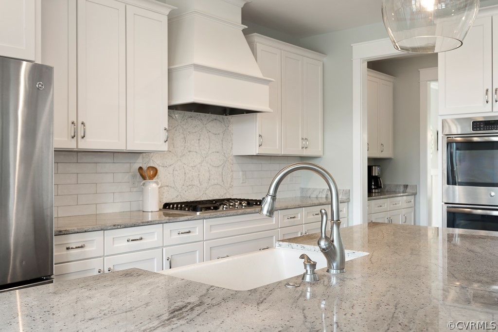 3812 Millmount Drive Powhatan, VA 23139 - Photo 17 of 48 a kitchen with stainless steel appliances granite countertop a sink a stove and a refrigerator