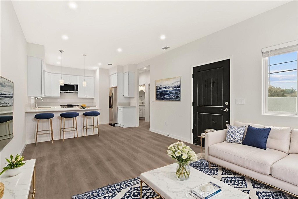 4508 Hedda Street, Unit 2 Lakewood, CA 90712 - Photo 2 of 10 a living room with furniture and kitchen view