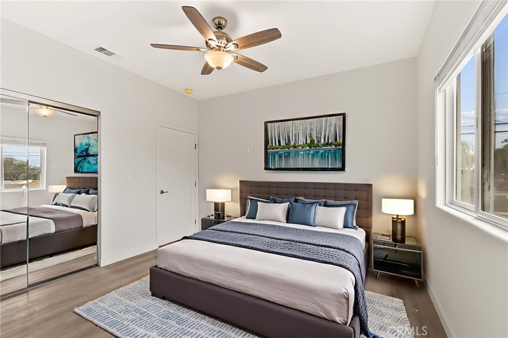 4508 Hedda Street, Unit 2 Lakewood, CA 90712 - Photo 7 of 10 a bedroom with a large bed and a chandelier