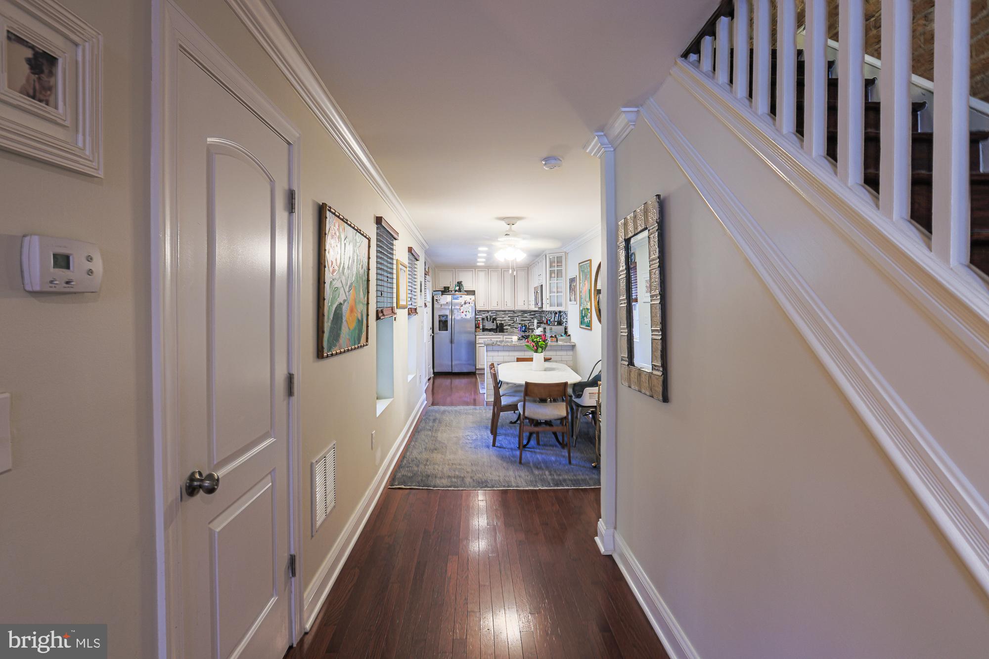 1446 Hull Street Baltimore, MD 21230 - Photo 12 of 54 a view of a hallway with wooden floor and furniture