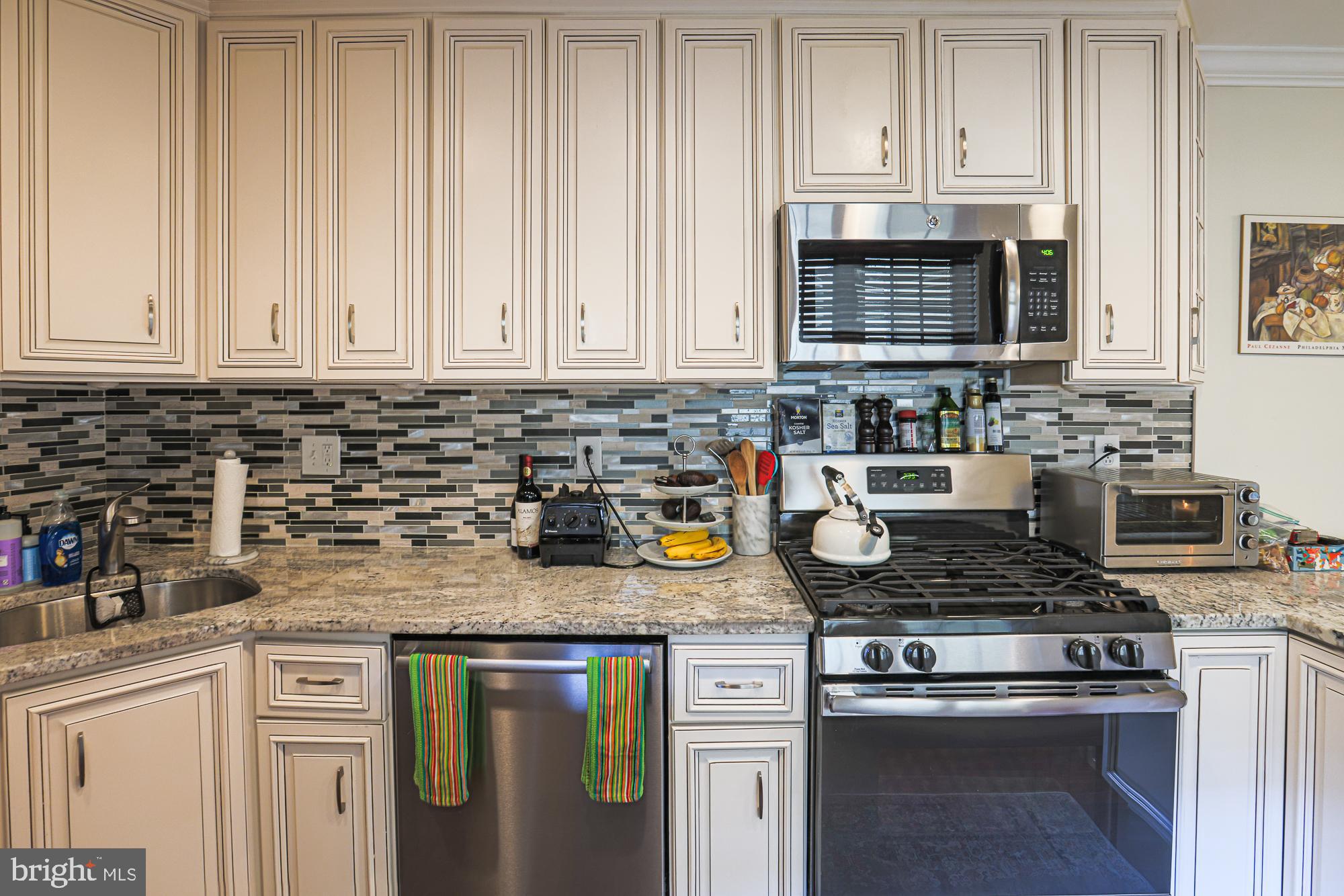 1446 Hull Street Baltimore, MD 21230 - Photo 20 of 54 a kitchen with stainless steel appliances granite countertop a stove a sink and a microwave