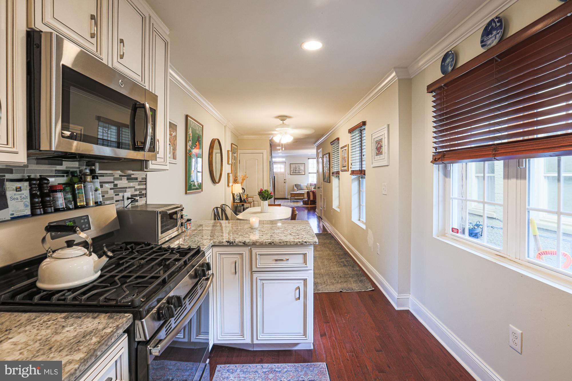 1446 Hull Street Baltimore, MD 21230 - Photo 22 of 54 a kitchen with stainless steel appliances granite countertop a stove a sink dishwasher a microwave oven with granite countertops and cabinets
