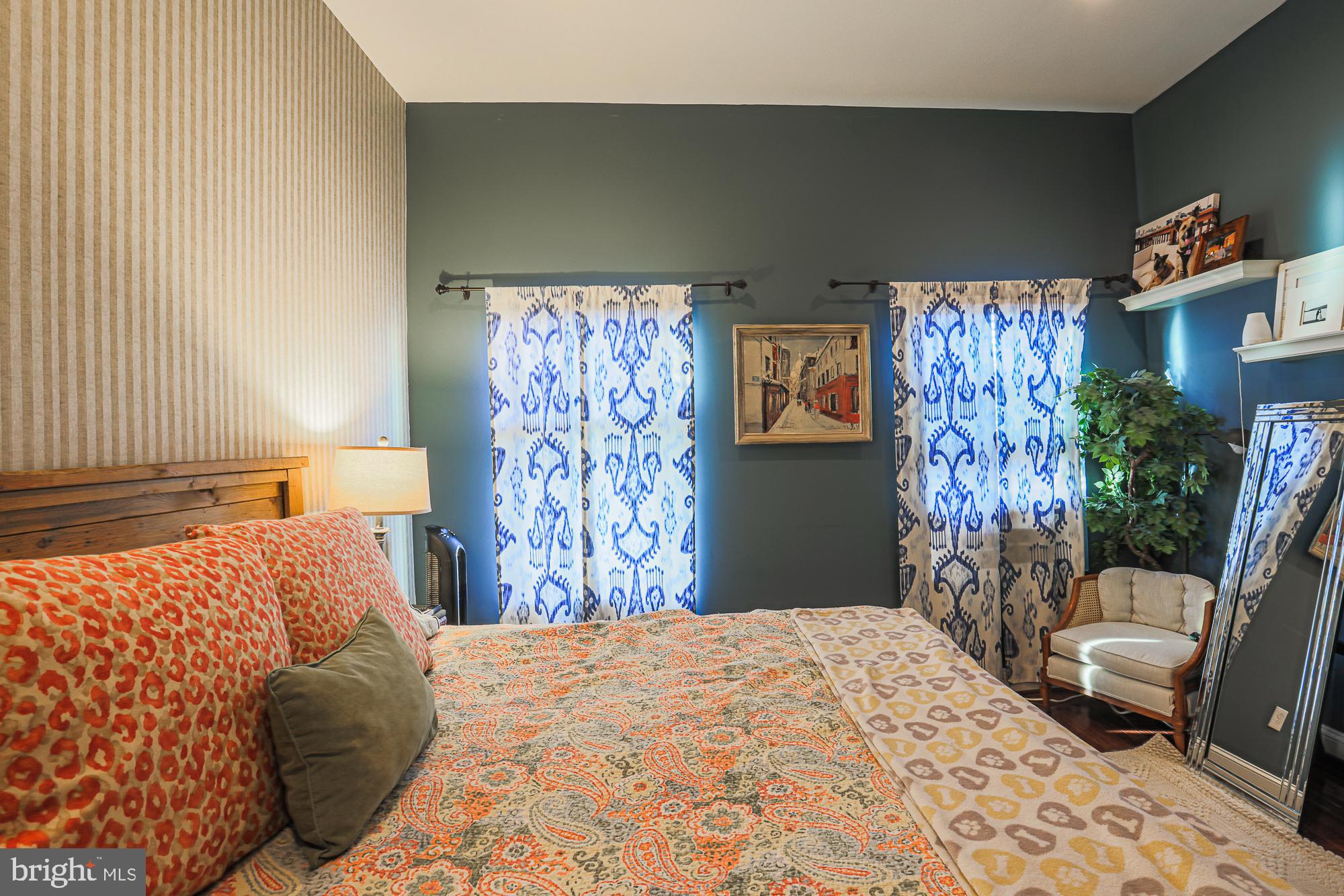 1446 Hull Street Baltimore, MD 21230 - Photo 29 of 54 a bedroom with a large bed dresser and a window