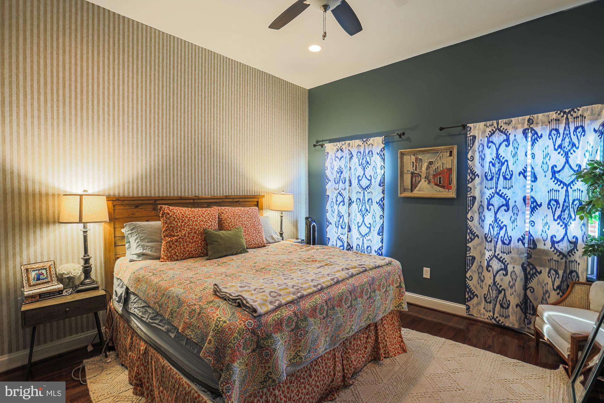 1446 Hull Street Baltimore, MD 21230 - Photo 31 of 54 a bedroom with a large bed and a chandelier