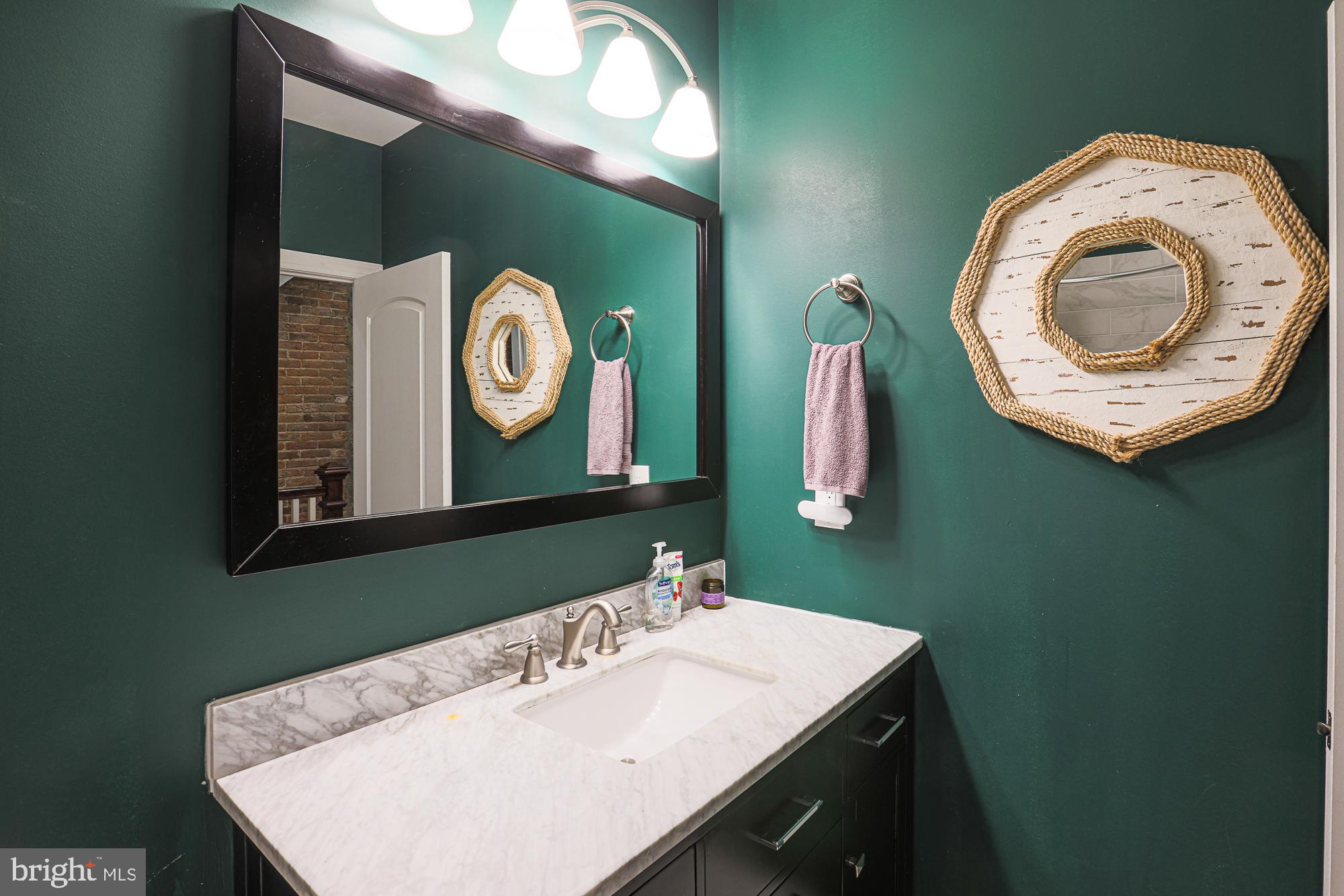 1446 Hull Street Baltimore, MD 21230 - Photo 43 of 54 a bathroom with a sink and a mirror