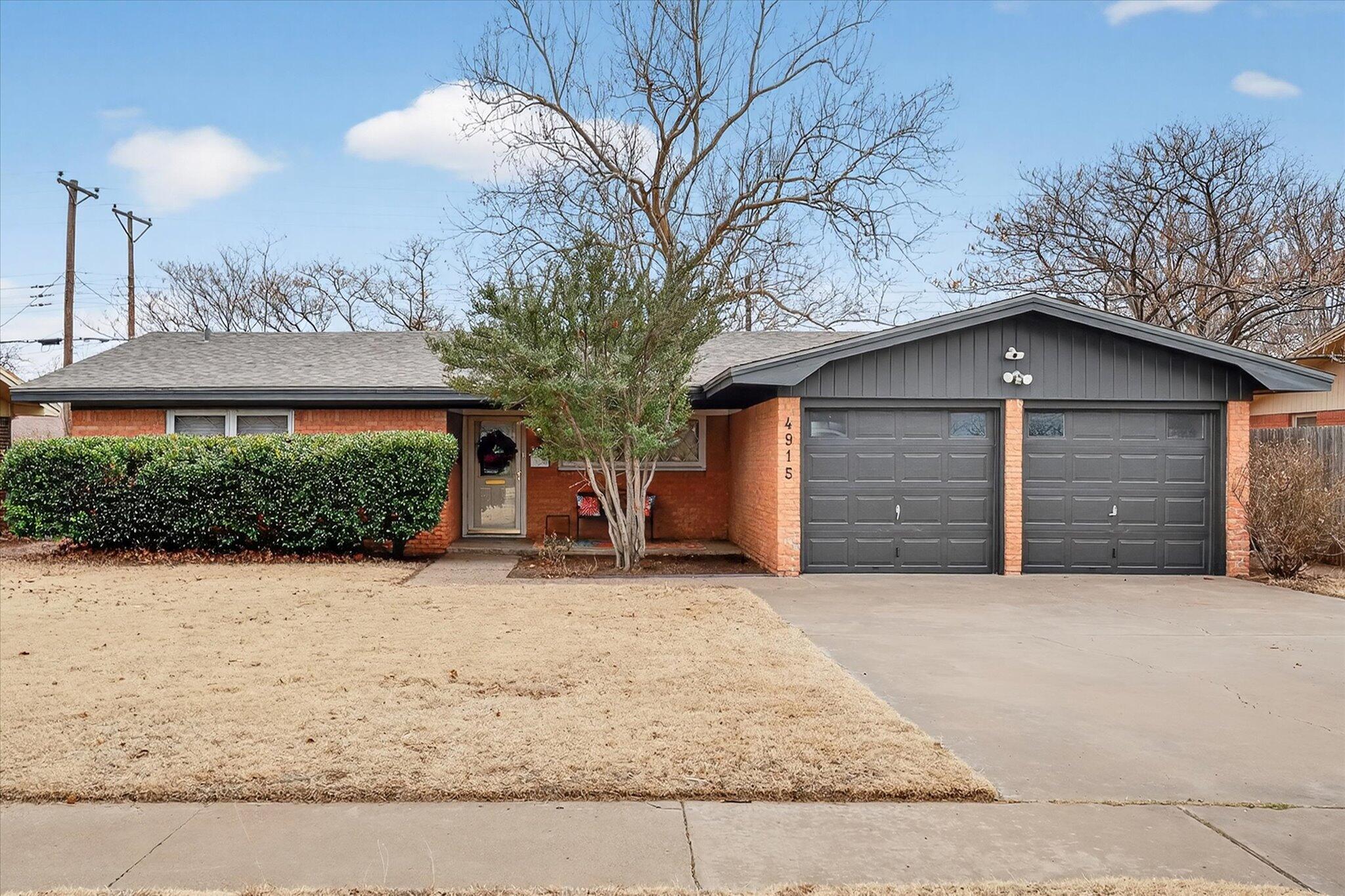 a view of a house with a yard and garage