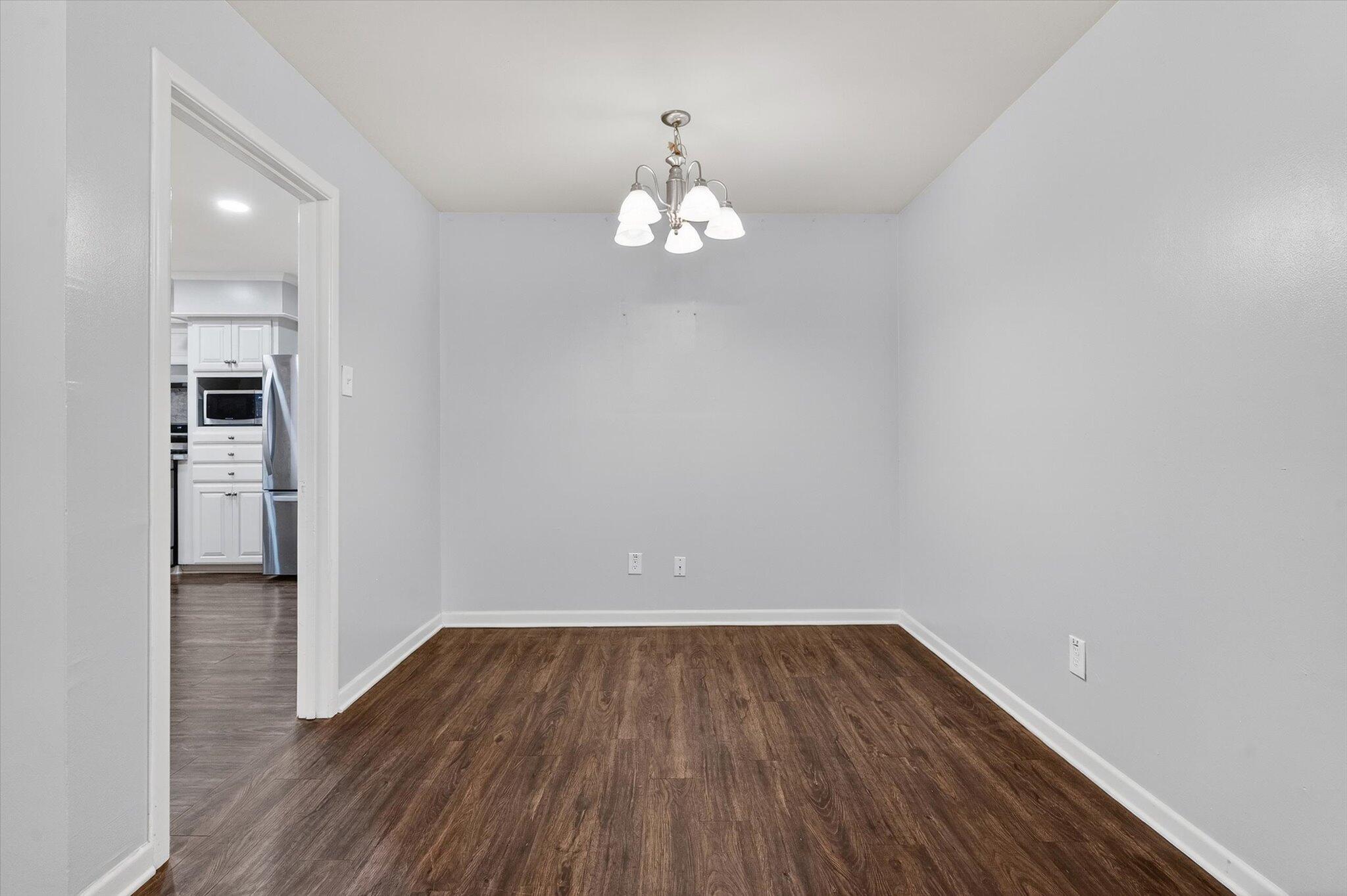 4915 17th Street Lubbock, TX 79416 - Photo 20 of 29 a view of wooden floor and a chandelier in a room