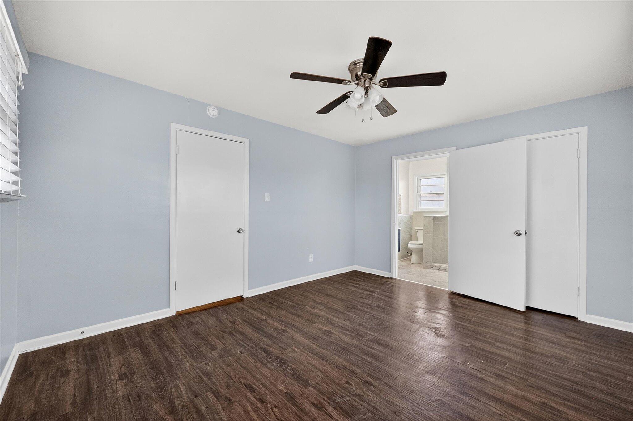 4915 17th Street Lubbock, TX 79416 - Photo 4 of 29 an empty room with wooden floor closet and windows