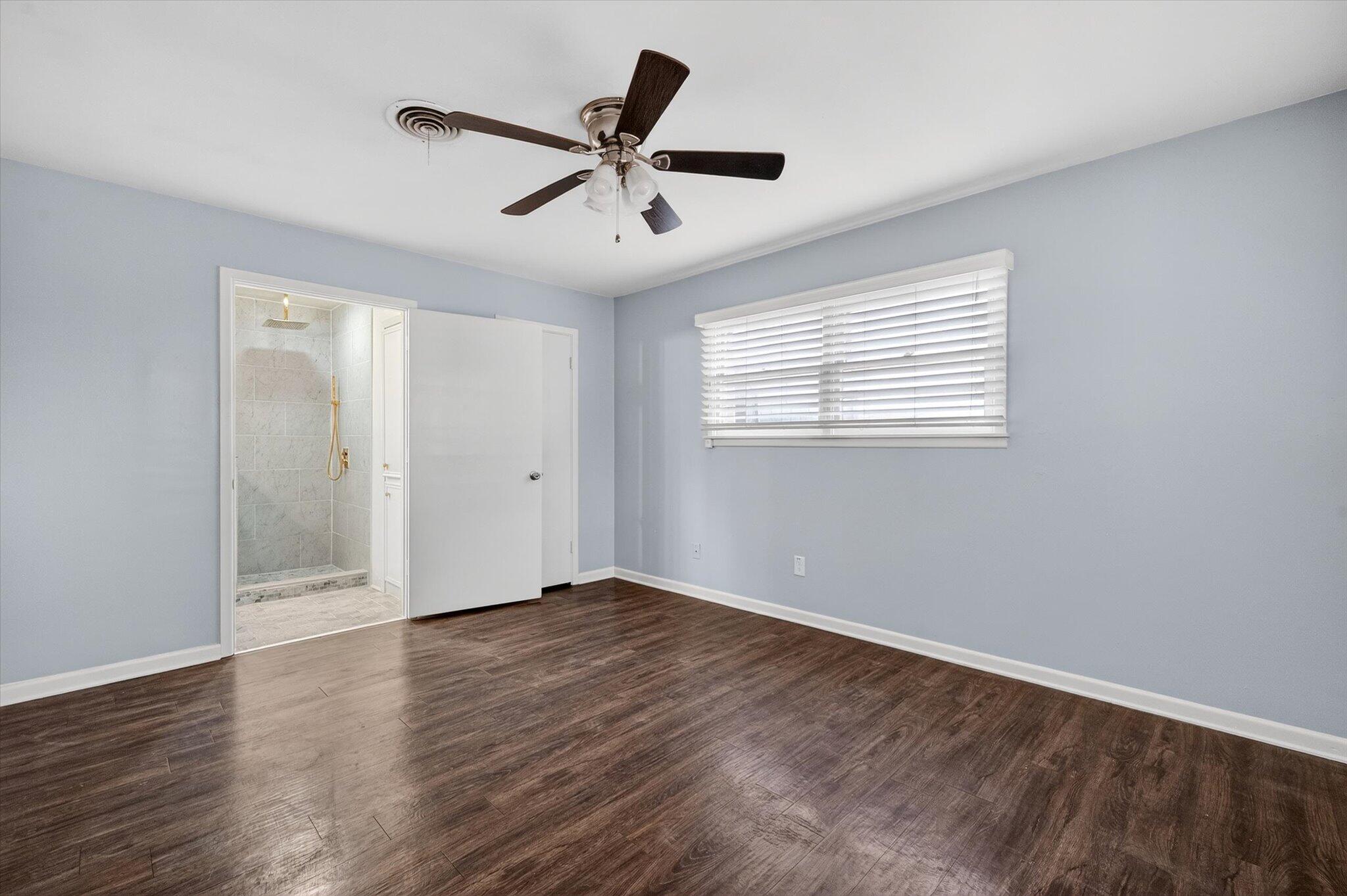 4915 17th Street Lubbock, TX 79416 - Photo 5 of 29 a view of an empty room with wooden floor and a window