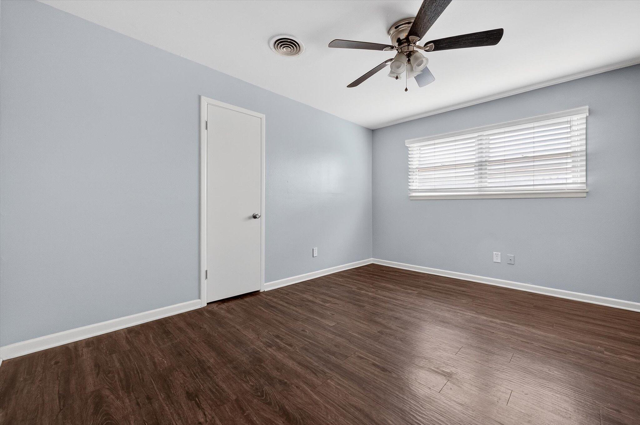 4915 17th Street Lubbock, TX 79416 - Photo 6 of 29 wooden floor in an empty room with a window