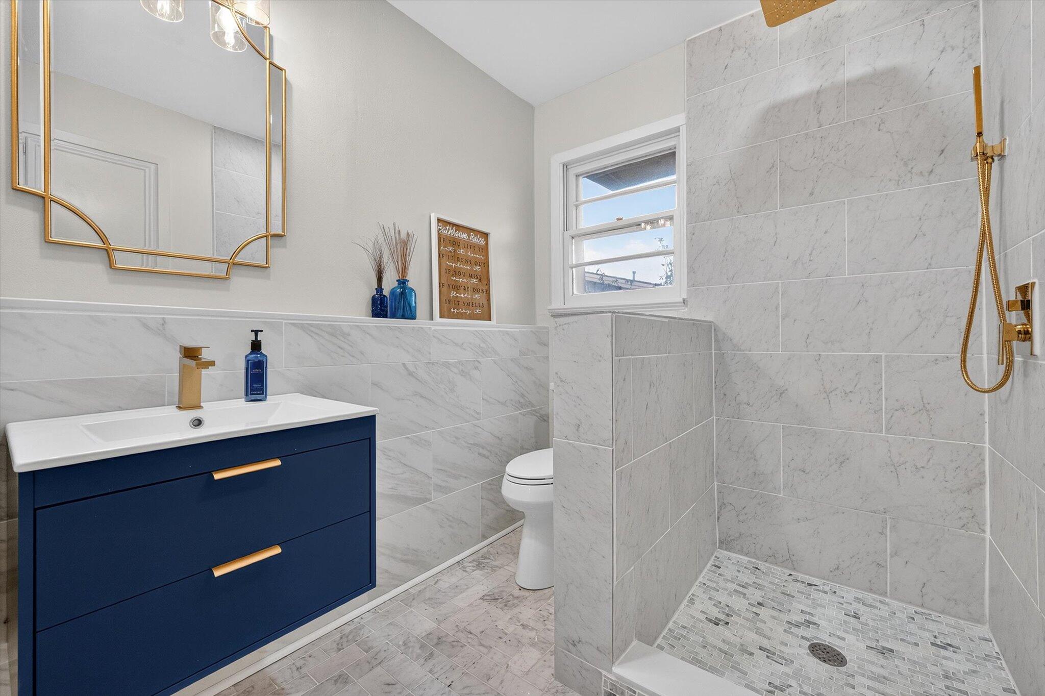 4915 17th Street Lubbock, TX 79416 - Photo 7 of 29 a bathroom with a sink a toilet and shower