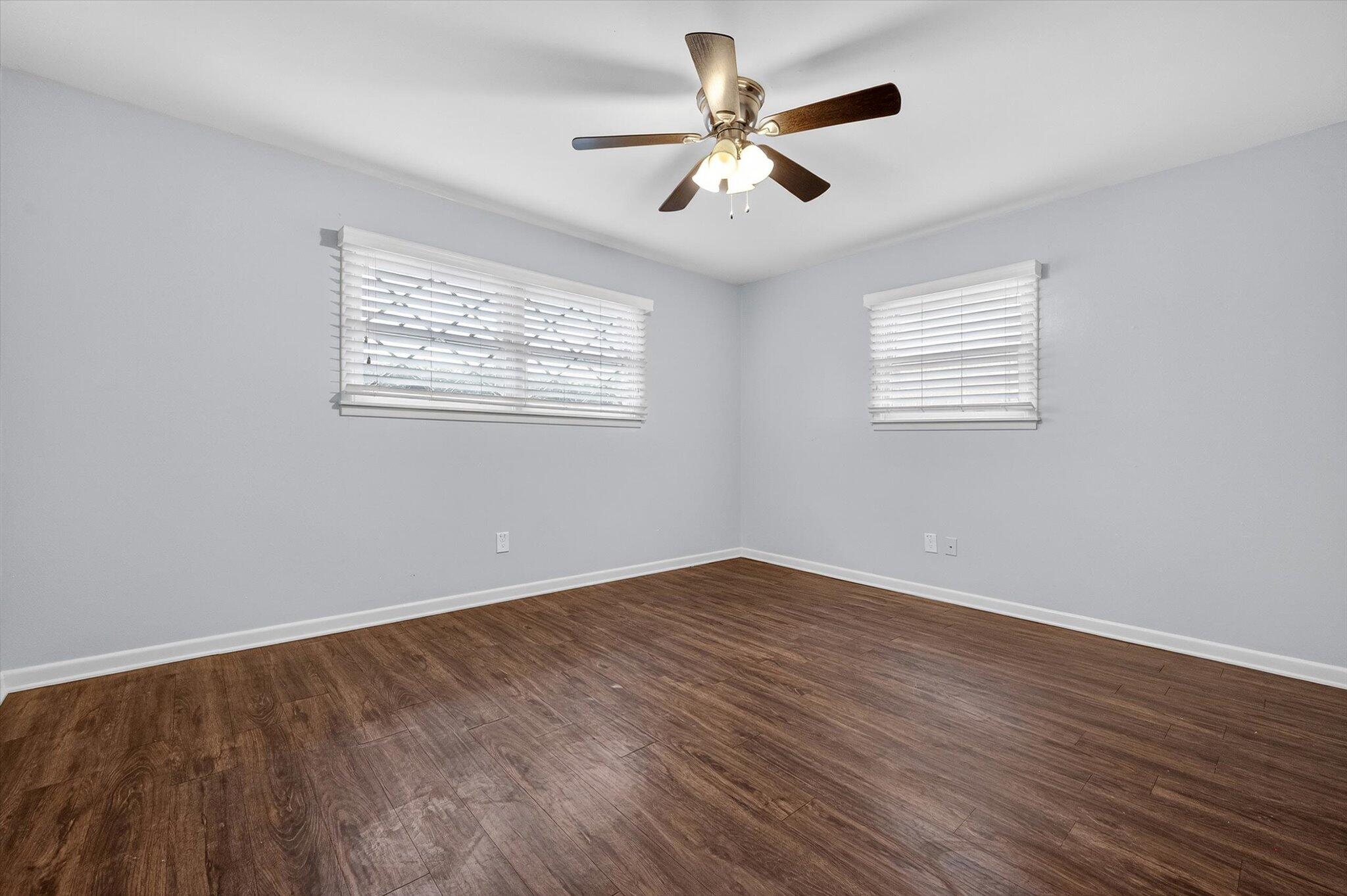 4915 17th Street Lubbock, TX 79416 - Photo 9 of 29 a view of an empty room with wooden floor and a window