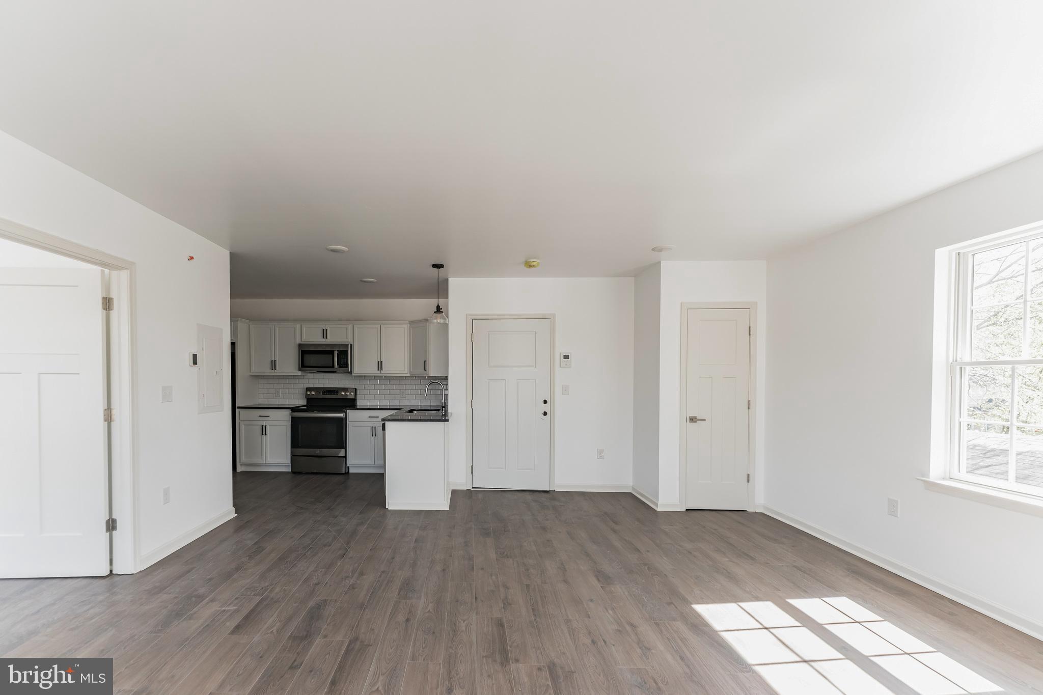 7105 Ridge Avenue, Unit A3 Philadelphia, PA 19128 - Photo 2 of 10 a view of a kitchen with wooden floor and a window